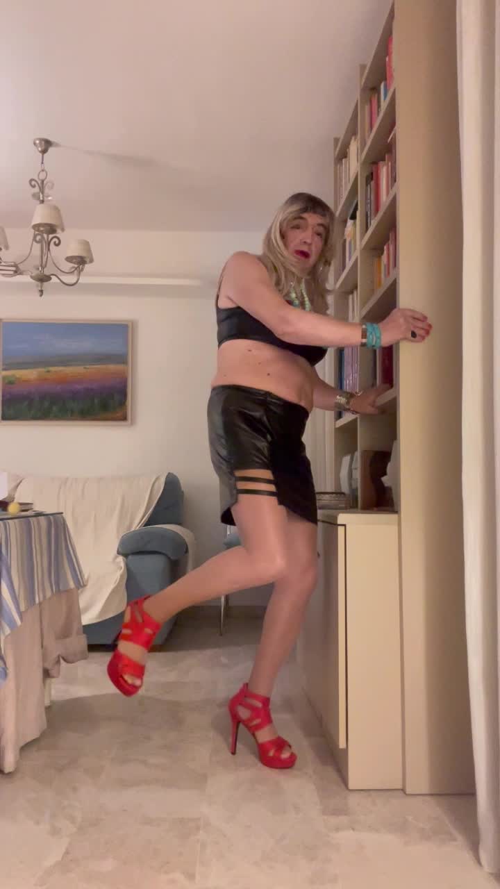 Beautiful Spanish shemale poses latex miniskirt high heels